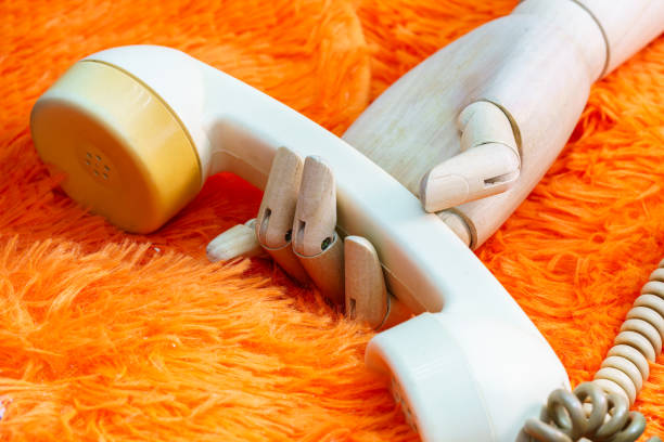 wooden hand holding a phone