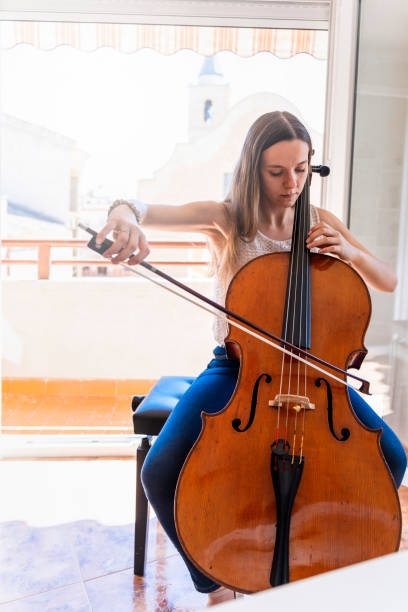 istock Professional Cellist Practicing at Home with Vintage Cello 1503921064
