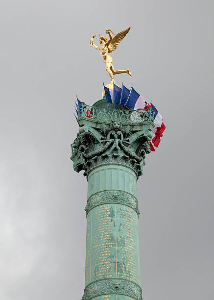 Flags decorate the July Tower at Place de la Bastille