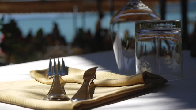 Glasses, Utensils and Napkin on the Restaurant Table, Close-Up