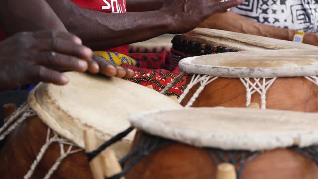 Hands of Black Musicians Playing African Traditional Drums Close-Up