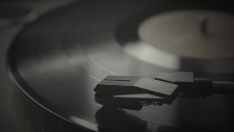 Vintage LP record on a turntable, grain and film damage.