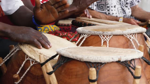 Hands of Black Musicians Playing African Music on Traditional Percussion