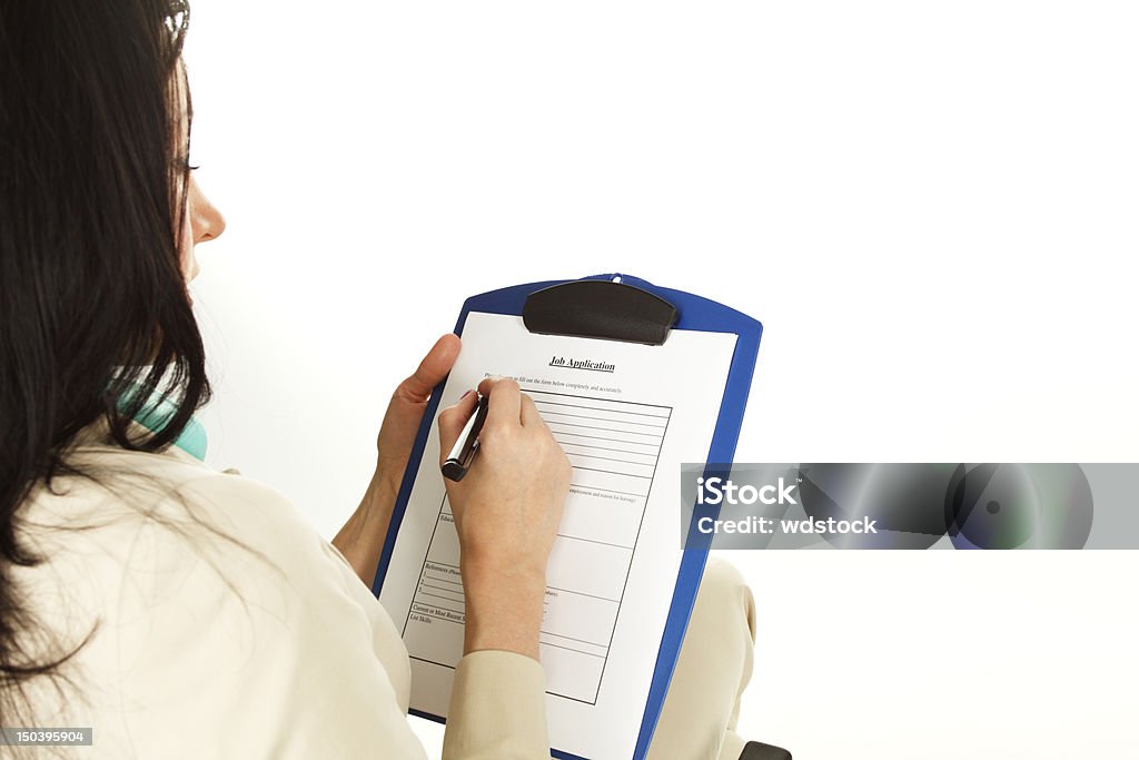 Filling Out Job Application Young woman filling out a job application. Focus is on application. 20-29 Years Stock Photo