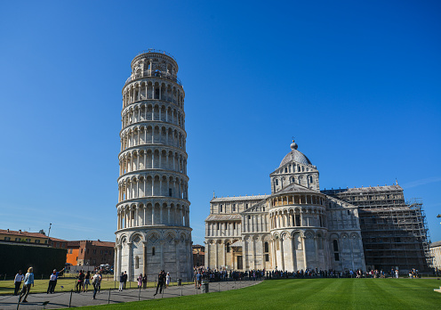 Pisa, Italy - Oct 18, 2018. Medieval Leaning Tower of Pisa (Torre di Pisa). The Tower began in 1173 and continued for about 200 years due to the onset of a series of wars.
