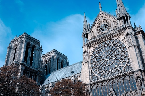 The Notre Dame de Paris cathedral, located in France, stands majestically against a clear blue sky