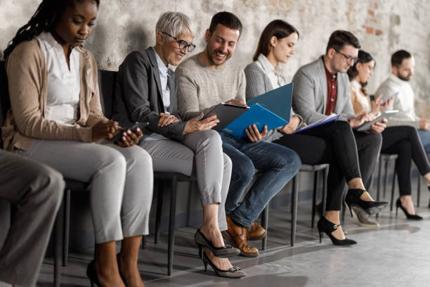 istock Happy business colleagues using touchpad while waiting for a job interview. 1503984347