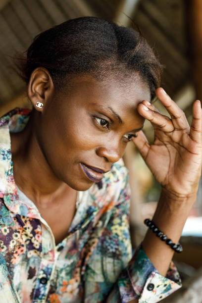 Worried black woman thinking of her problems on a balcony.