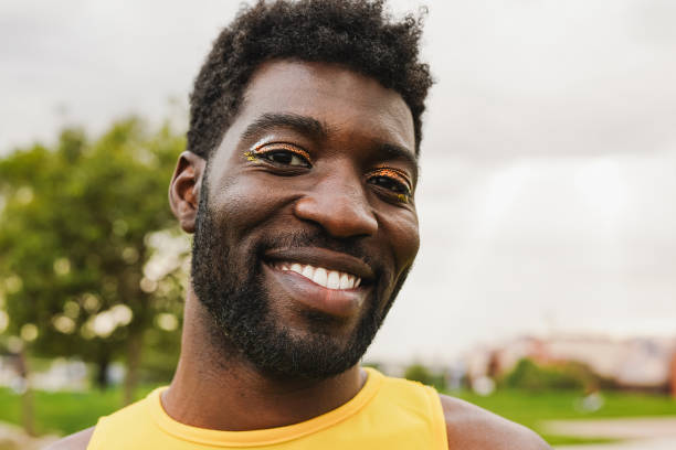 istock Young gay african man with make up smiling on camera 1503992022