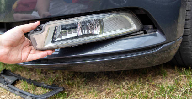 istock Disassembling and removing the fog lamp from a car to replace a burnt out light bulb. Close-up 1503992199