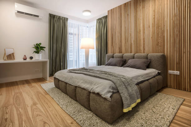 istock Double bed, table, wooden wall and large window in comfortable bedroom 1503998522