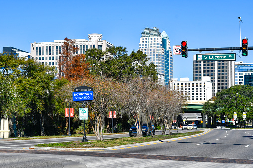 Welcome to downtown Orlando road sign with professional office buildings in the background near central Florida