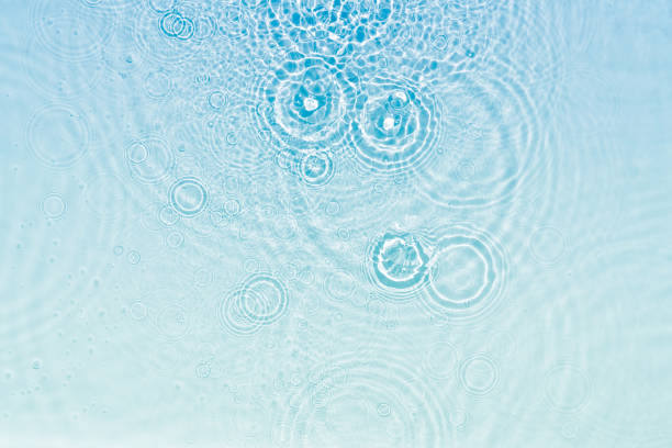 istock abstract fresh transparent blue water surface from above with rain drop circles in sunlight 1504020241