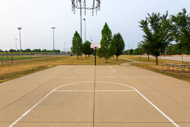 istock two open basketball courts on a smoky sky morning 1504023909