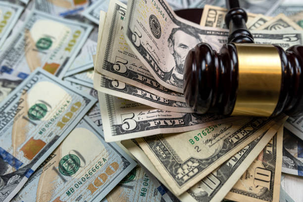 istock wooden hammer on one hundred dollar bill 1504041432