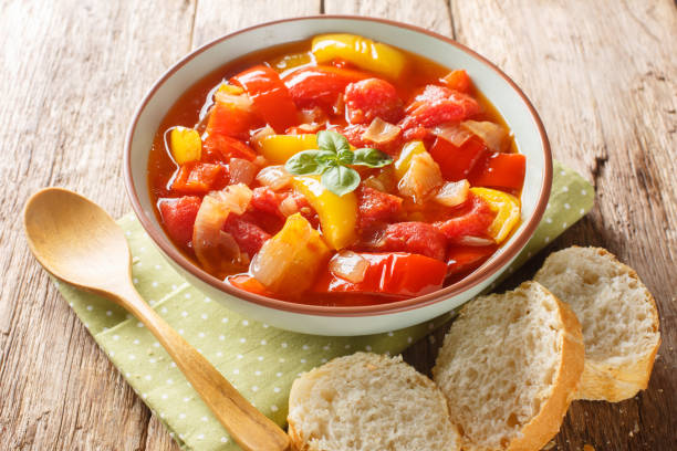 Homemade vegetable bell pepper stew with onions, garlic and tomatoes close-up in a bowl. Horizontal stock photo