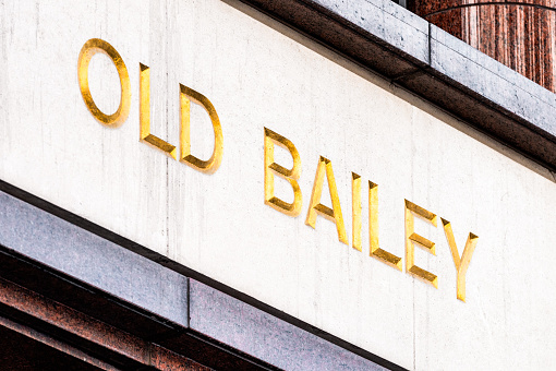 A gilded sign for the street Old Bailey in the City of London. The street is well known as the location for the Central Criminal Court.