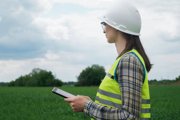 istock electrical engineer woman high voltage power industry, electrician worker working, energy concept, high voltage electrical tower, power line, working tablet 1504041567