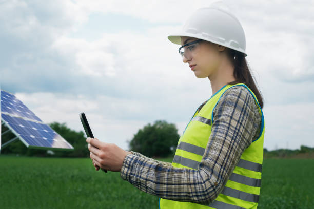 istock Portrait of a technical engineer with a tablet in his hands, standing in front of an unfinished tall outdoor solar panel of a photovoltaic system, technical engineer girl 1504042322