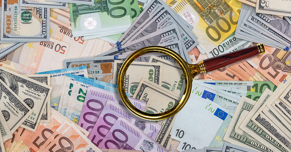 different dollar and eu euro bills with magnifying glass, finance concept. Business concept. Main international currency