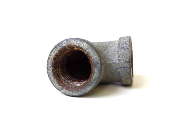 istock Close up of rusty metal pipe fitting isolated on white background. 1504058703