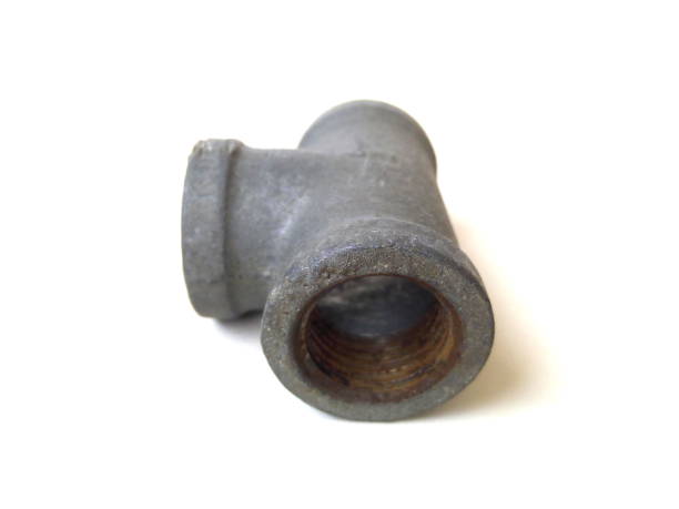 istock Close up of rusty metal pipe fitting isolated on white background. 1504058709