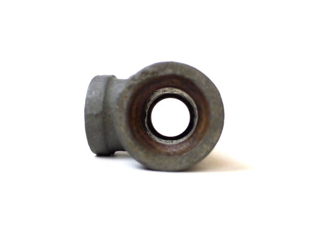 istock Close up of rusty metal pipe fitting isolated on white background. 1504058713