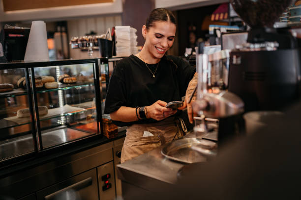 istock Small business owner holding a smartphone in her cafe 1504070952