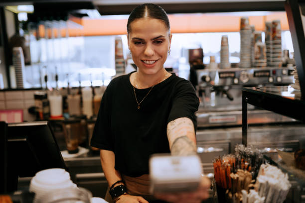 istock Tattooed barista making coffee in professional coffee machine 1504071498