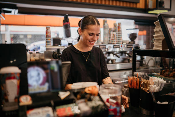 istock Small business owner holding a smartphone in her cafe 1504072038
