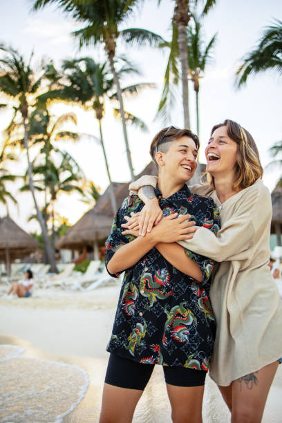 istock Same sex couple enjoying at the beach 1504085451