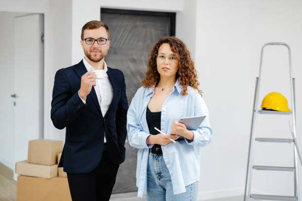istock Young designer and customer businessman are designing interior standing with digital tablet in the new living room interior 1504089333