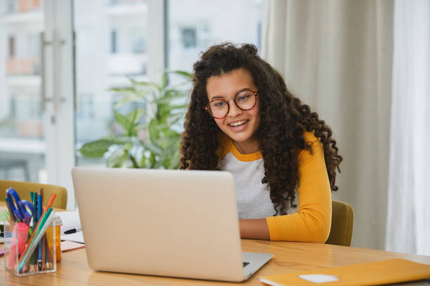 istock Beautiful student sitting at her desk having a video call 1504091163