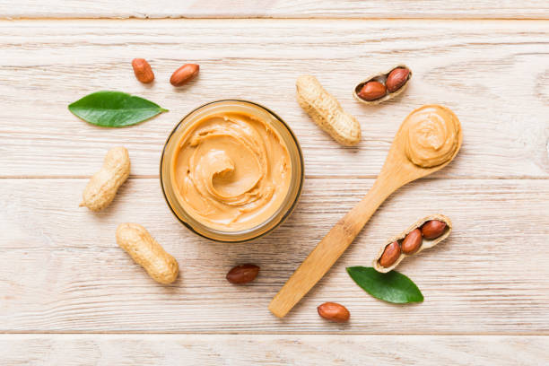 istock Bowl of peanut butter and peanuts on table background. top view with copy space. Creamy peanut pasta in small bowl 1504100115