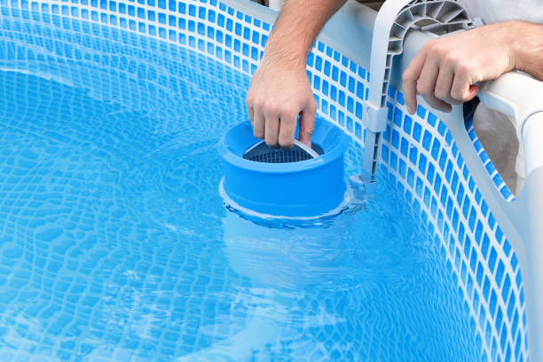 istock Man cleans skimmer for the frame pool. Contaminated pool cleaning concept 1504100160