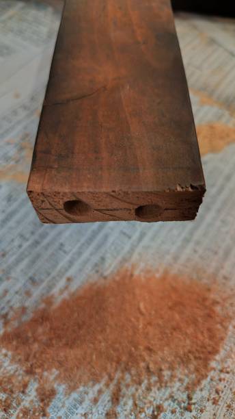 istock Drilling holes in an old wooden board 1504105025