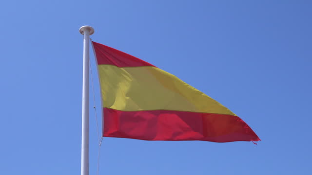 Spanish flag waving in the wind on a flagpole