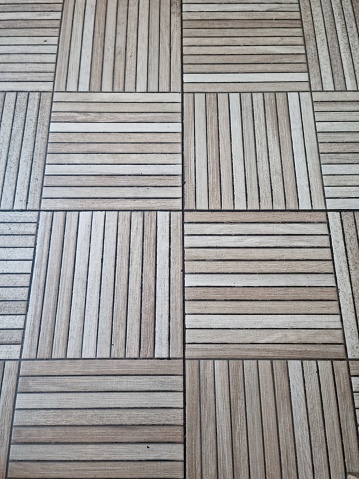 Picture taken from above of floor made of wood with combination of vertical and horizontal placement
