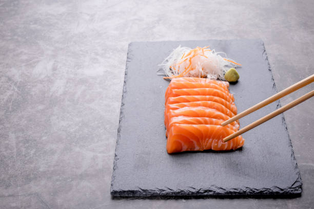 istock The salmon sashimi was laid out on a black stone plate 1504128654