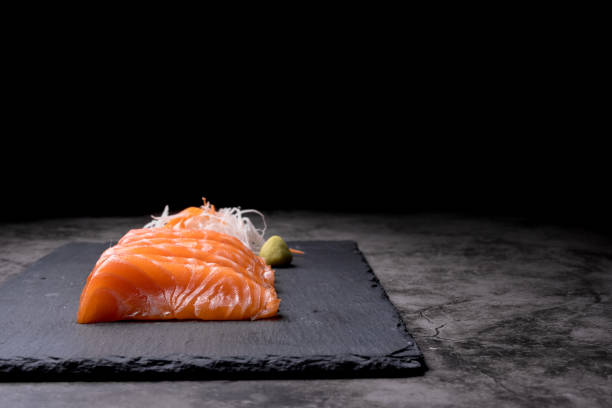 istock The salmon sashimi was laid out on a black stone plate 1504128659