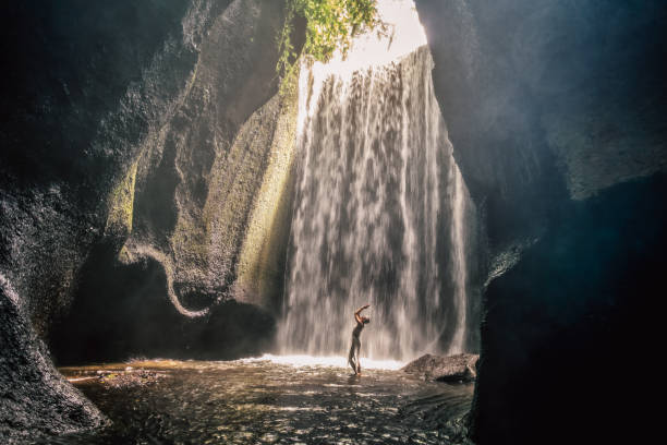 istock Woman staying under waterfall, Bali 1504128868
