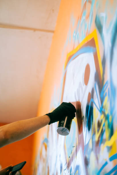 istock Young caucasian man graffiti artist drawing on a wall. 1504129538