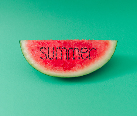 Creative summer watermelon layout on light pastel green background. Minimal summer fruit concept. Trendy food arrangement. Watermelon aesthetic.