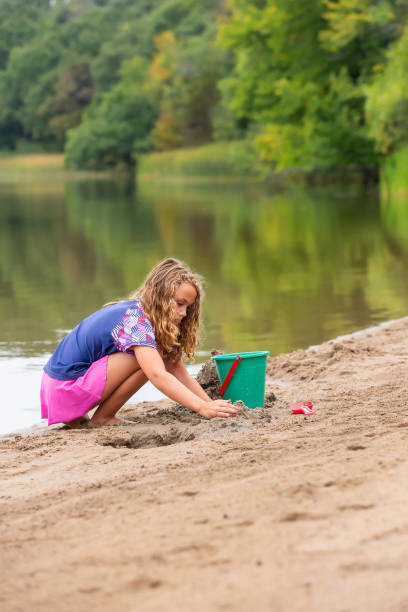 istock Girl Playing In Sand at Beach on Summer Day 1504135515