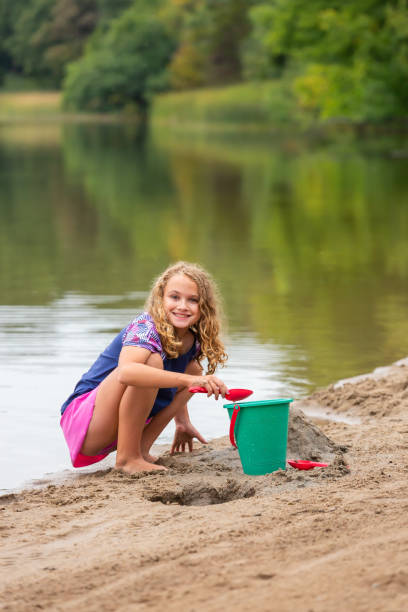 istock Girl Playing In Sand at Beach on Summer Day 1504135537