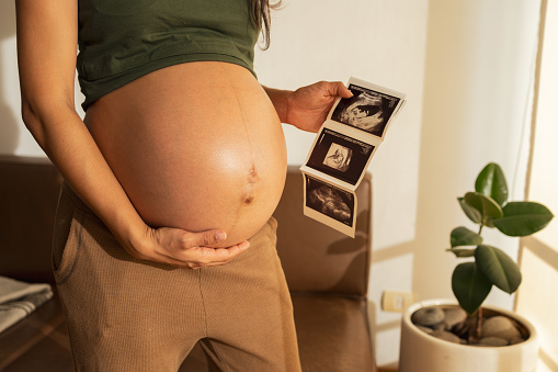 Point of view, Latin woman looking at ultrasound scan at home