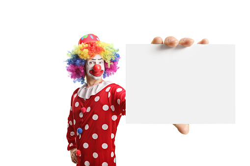 Clown holding a blank card isolated on white background
