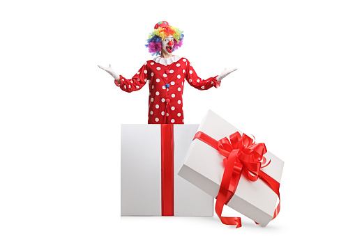 Clown standing inside a gift box isolated on white background