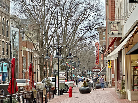 Charlottesville, Virginia, USA - Historic Downtown Mall in Charlottesville Virginia with people visible. This pedestrian mall is home to a collection of many shops and restaurants located in the historic buildings on and around old Main Street Charlottesville.