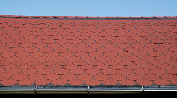 istock Roof with red bitumen shingles and metal gutter close 1504174750